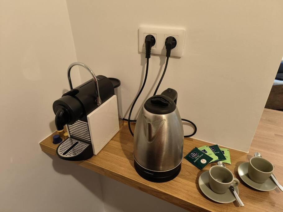 a table with a coffee maker and a tea kettle at Charmant studio - Gare colmar in Colmar