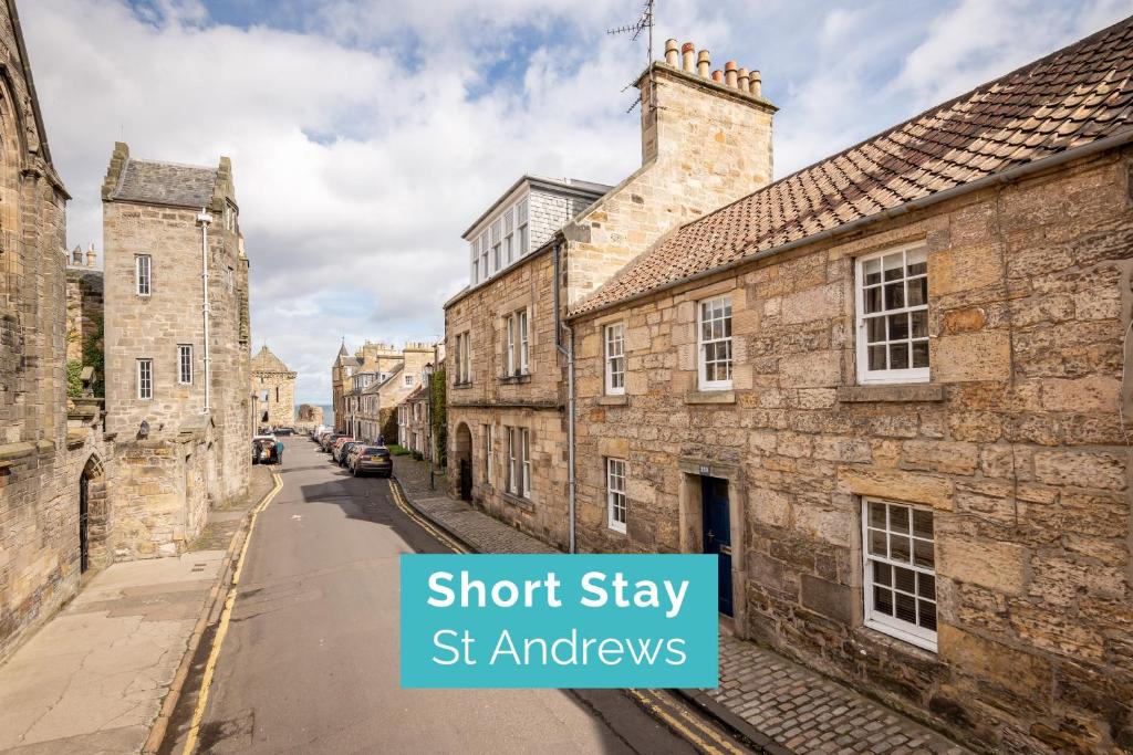 a street in an old town with stone buildings at Castle Loft - 2 Bed - Central - Close to castle in St. Andrews