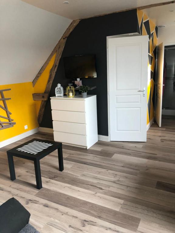 a room with a white door and a dresser at Le champ des granges in Briare