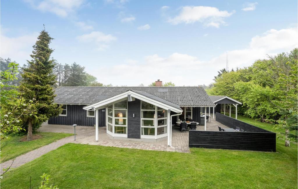 a house with a black and white exterior at Nice Home In Hjrring With 4 Bedrooms, Sauna And Wifi in Lønstrup