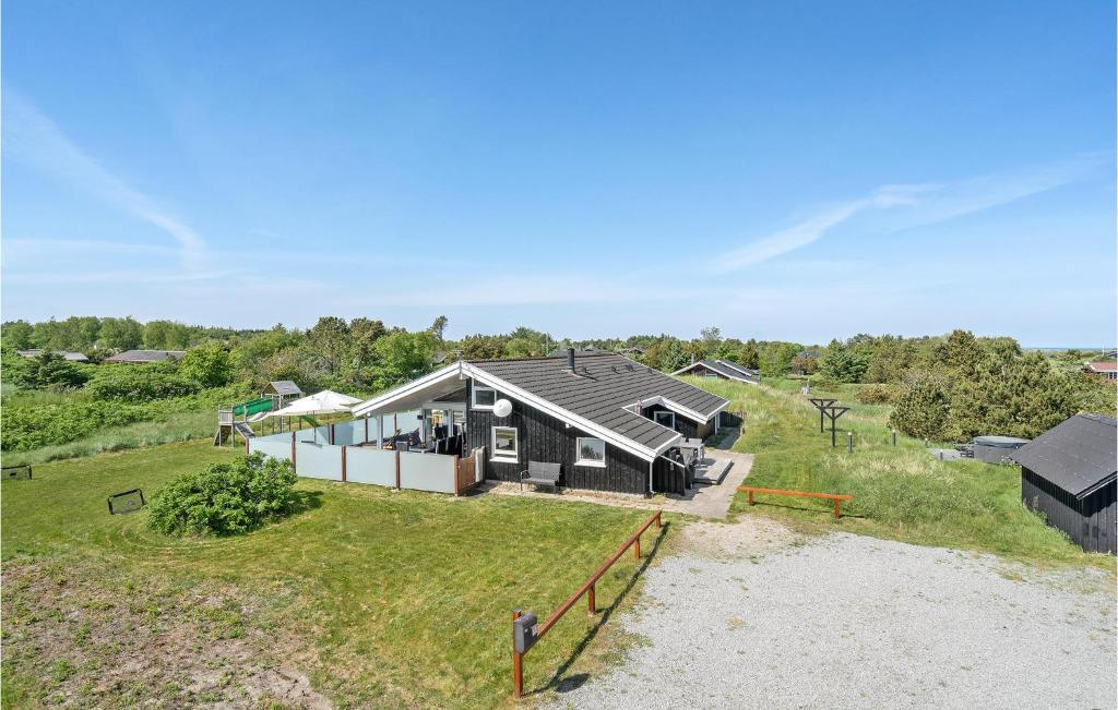 an aerial view of a house on a beach at Nice Home In Bindslev With 4 Bedrooms, Sauna And Indoor Swimming Pool in Bindslev