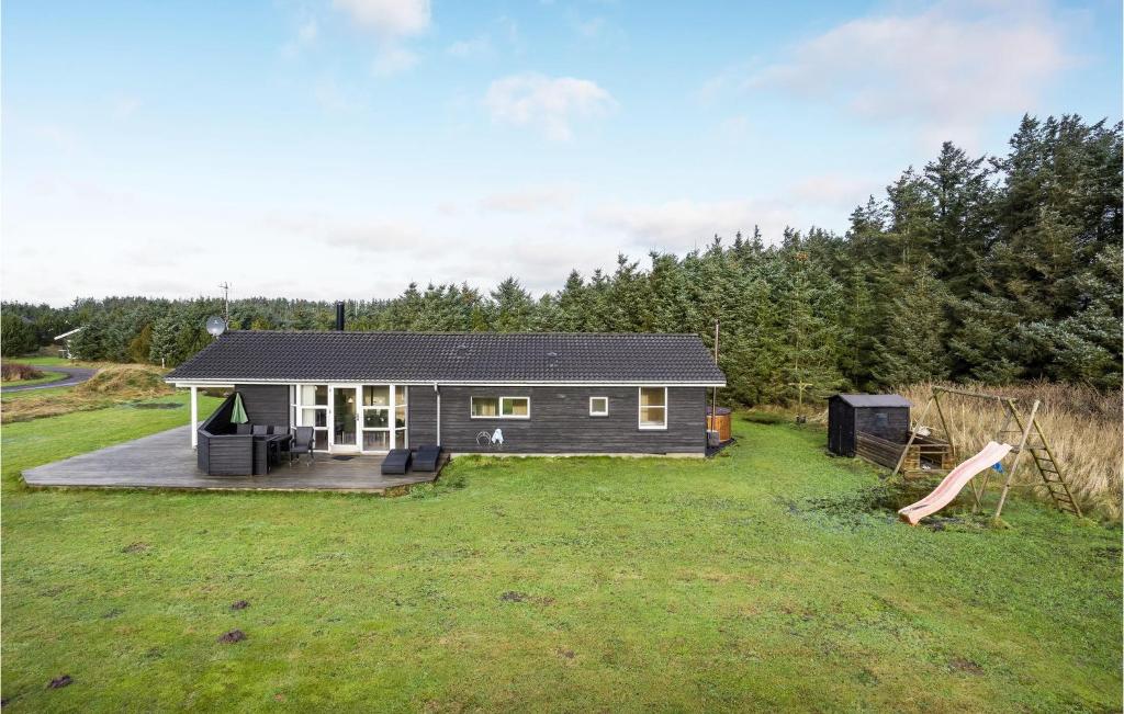 a small house in the middle of a yard at Pet Friendly Home In Lkken With Wifi in Løkken