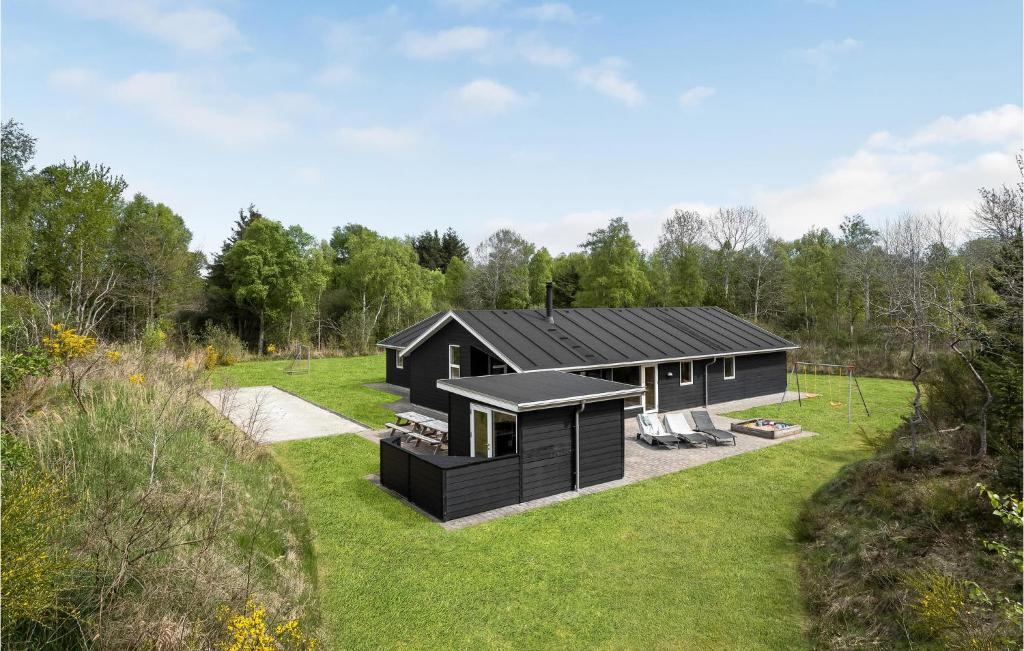 a black house with a black roof at Holiday Home Næsehornsvej Ålbæk X in Ålbæk