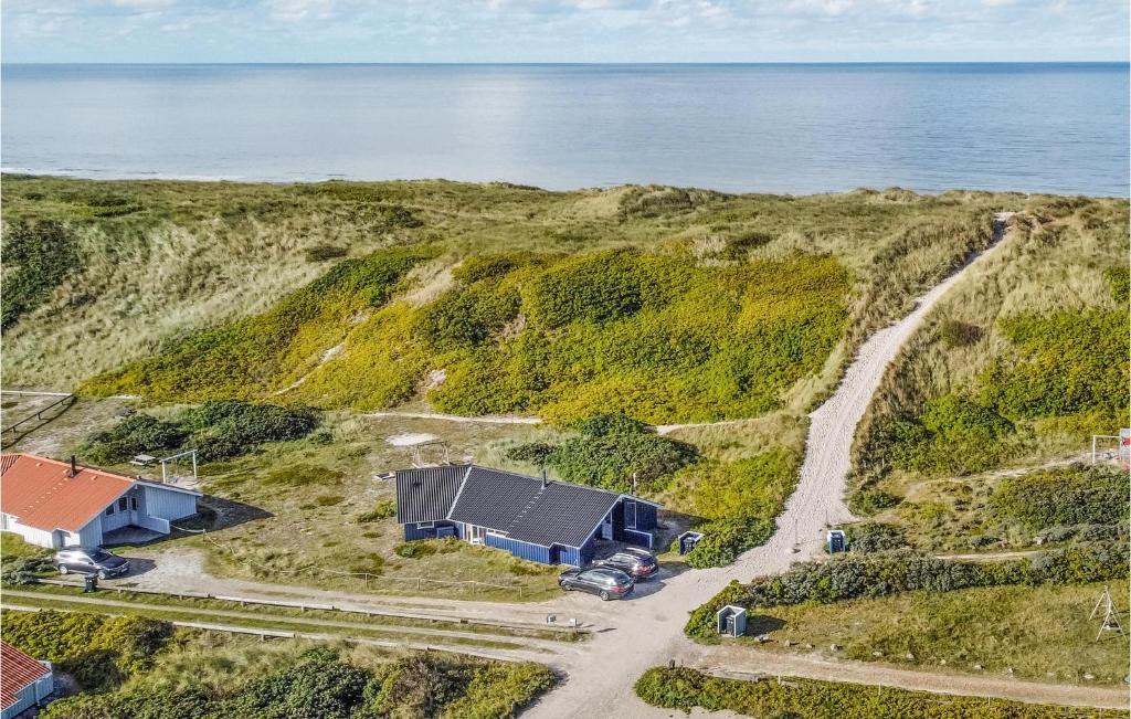 an aerial view of a house on a cliff next to the ocean at Holiday Home Rauhesvej Ix in Bjerregård