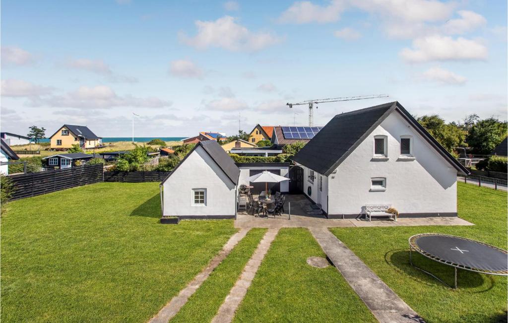 an aerial view of a white house with a yard at 5 Bedroom Amazing Home In Strandby in Strandby