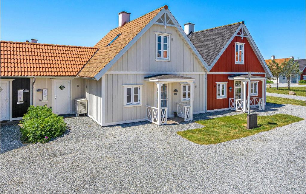 una gran casa roja y blanca con garaje en Blvandslyst, en Blåvand