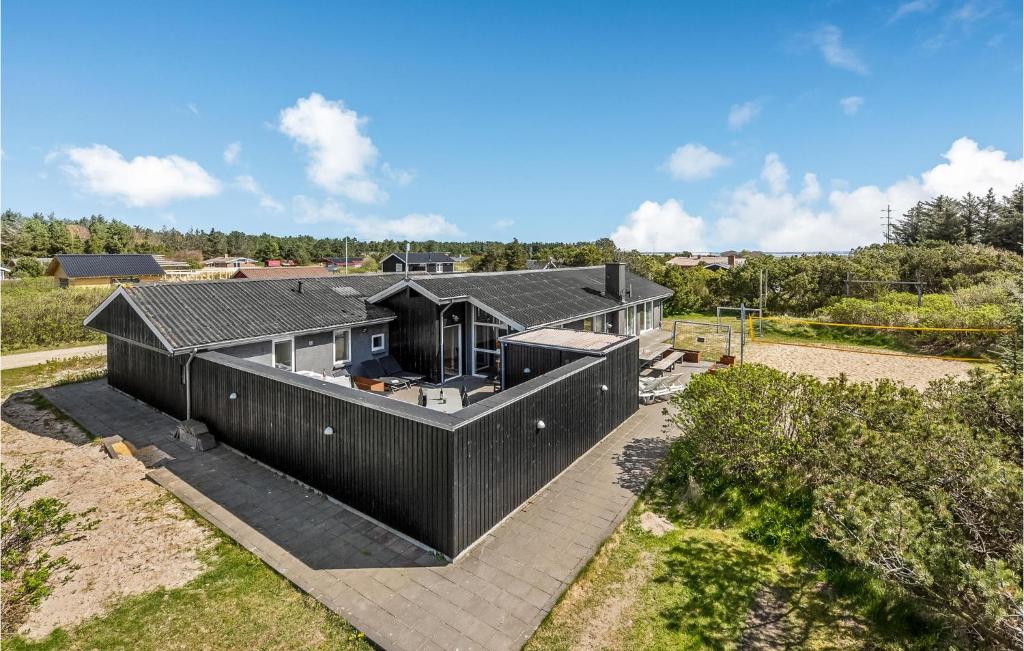 an overhead view of a house with a black roof at Awesome Home In Ringkbing With Indoor Swimming Pool in Klegod