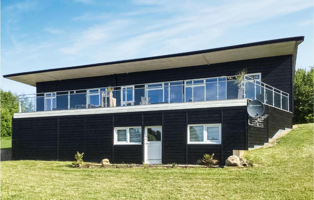 a black house with a lot of windows at Beautiful Home In Spttrup With Sauna in Spottrup