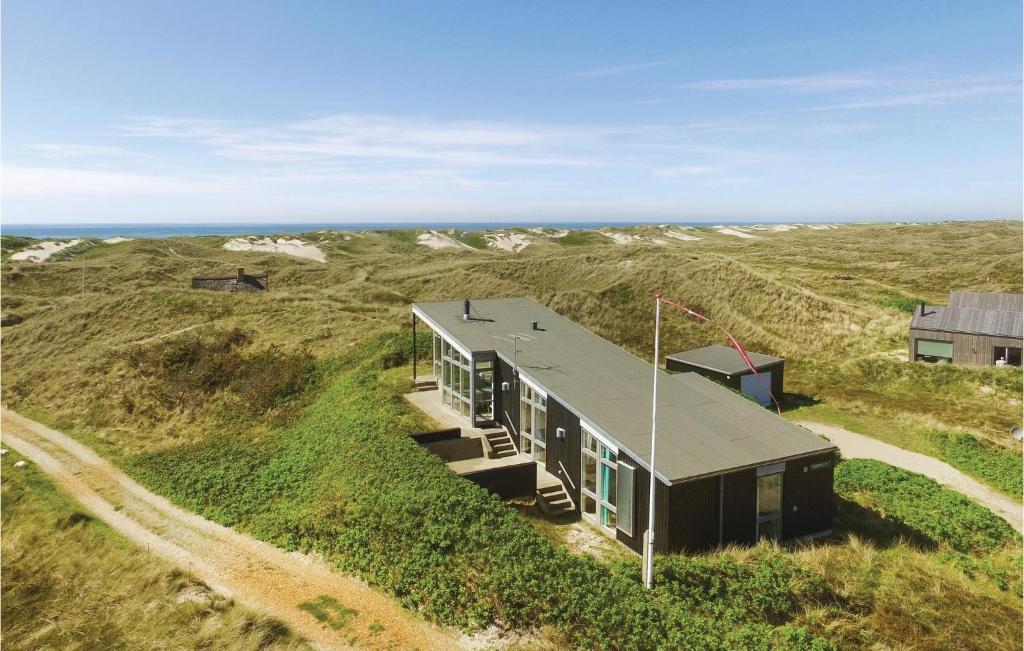 a house on a hill with the ocean in the background at Holiday Home Holdvej in Ringkøbing