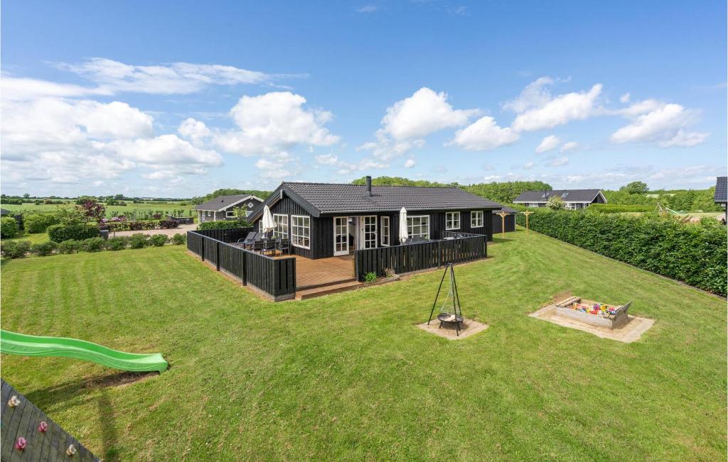 a large yard with a house and a swing at 5 Bedroom Amazing Home In Haderslev in Flovt