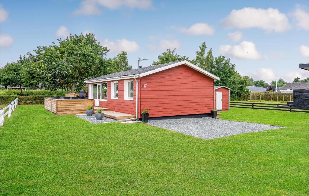 a red tiny house in a yard at Nice Home In Haderslev With Kitchen in Kelstrup Strand