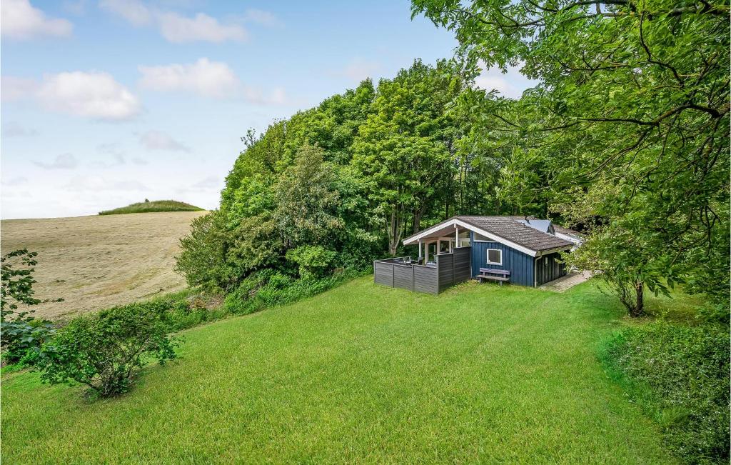 a small cabin in the middle of a grass field at 3 Bedroom Awesome Home In Mrslet 