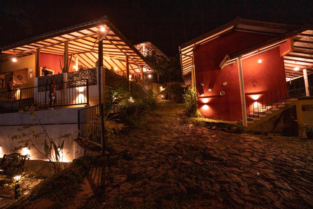 a house with lights on the side of it at night at Kuru Ganga Villa in Eratnagoda