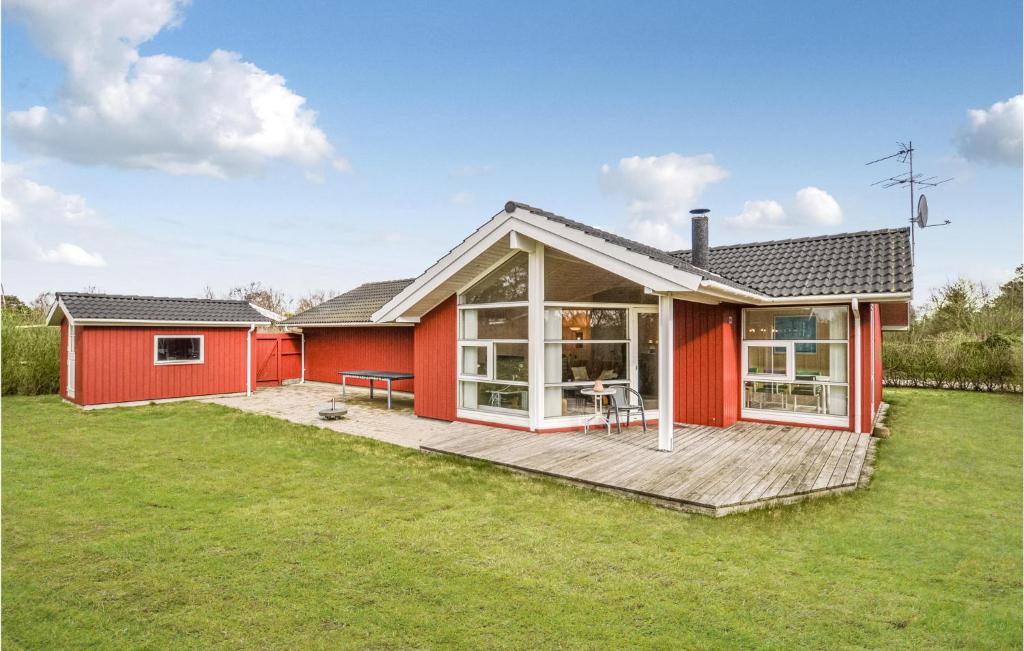 a red house with a deck in the yard at Nice Home In Slagelse With Wifi in Slagelse