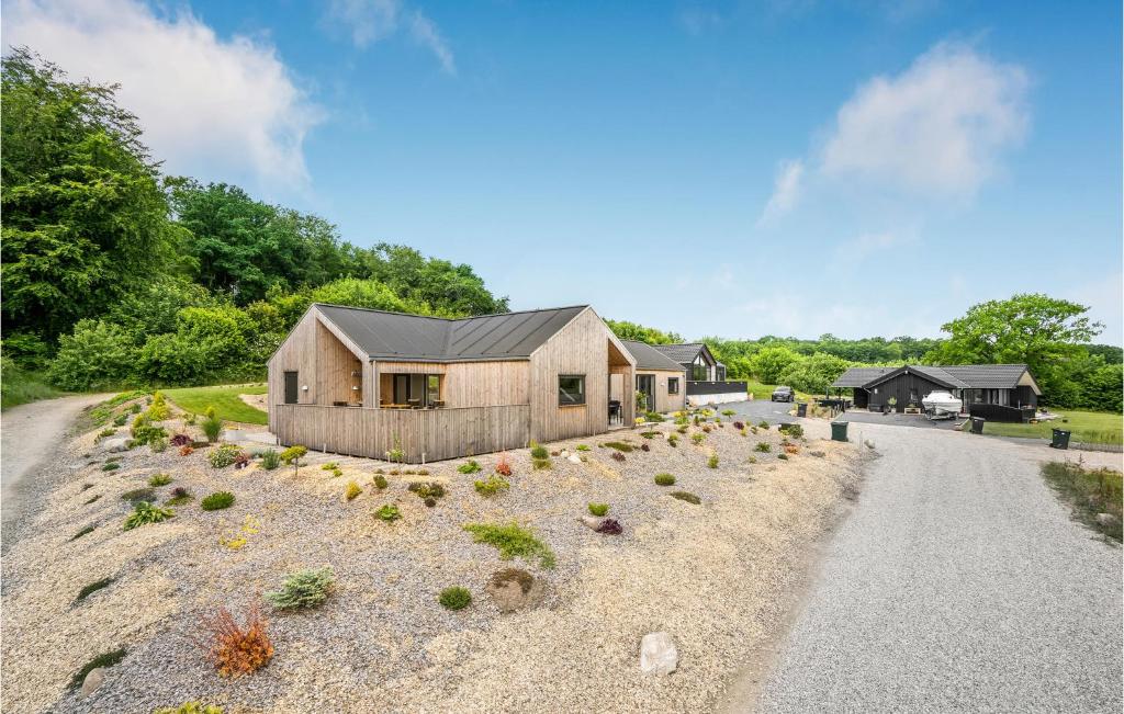 a house on a hill with a gravel road at 4 Bedroom Stunning Home In Sjlund in Sjølund