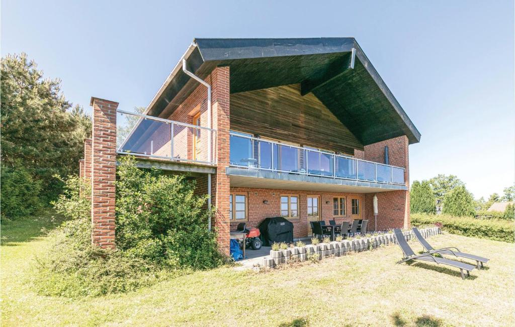 a large brick house with a large balcony at Alpehuset in Allinge
