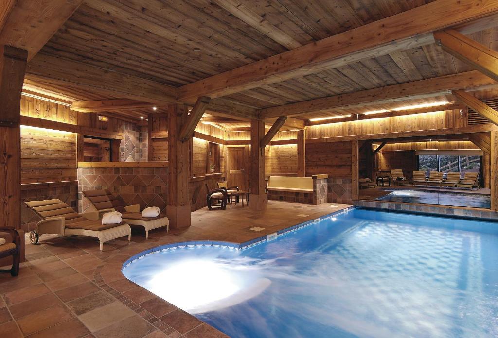 - une grande piscine dans une maison en bois dans l'établissement Relais et Châteaux - Les Bas-Rupts, à Gérardmer
