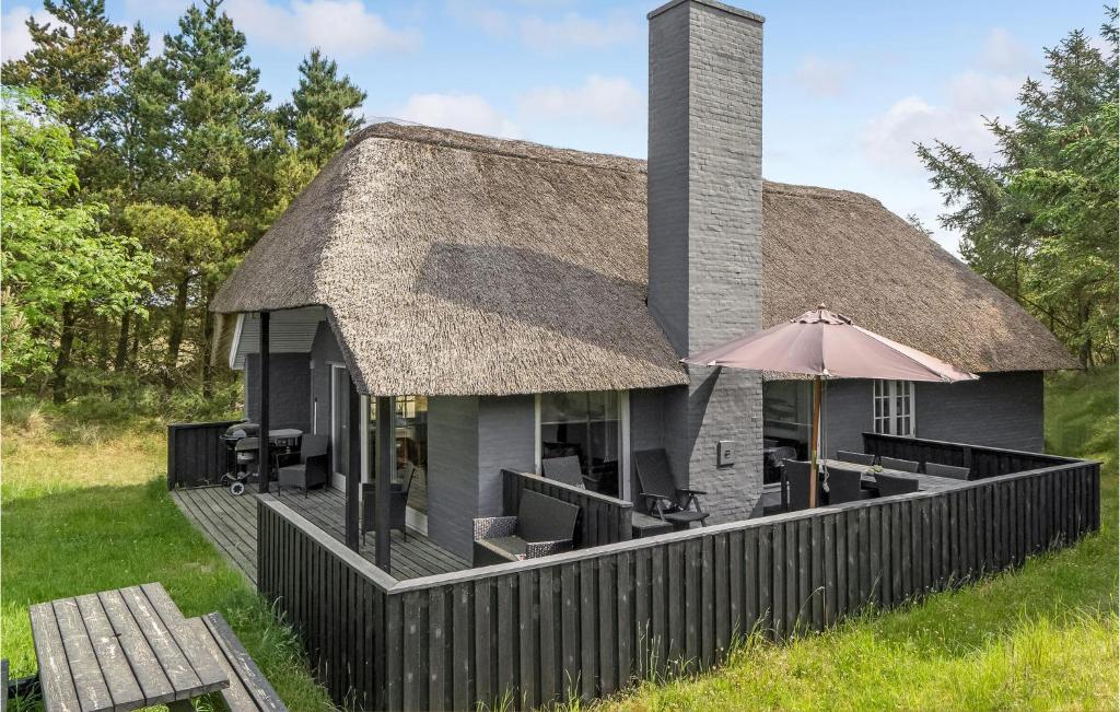 ブラーバンドにあるStunning Home In Blvand With 3 Bedrooms, Sauna And Wifiの傘付きのデッキのある家