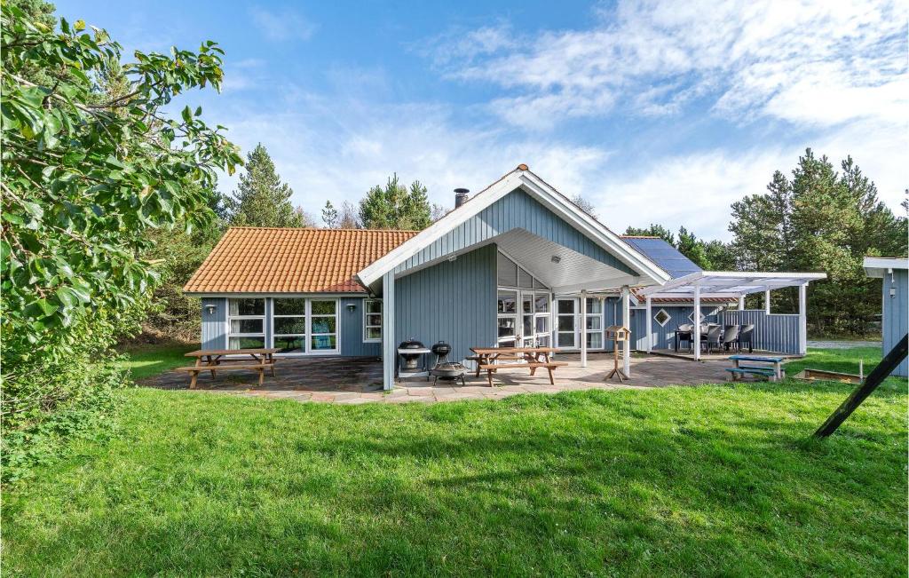 a house with a deck and a patio at Awesome Home In Jerup With 4 Bedrooms, Sauna And Private Swimming Pool in Jerup