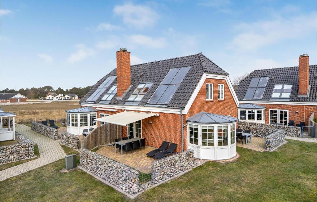 a house with solar panels on the roof at Three-Bedroom Holiday Home In Romo in Havneby