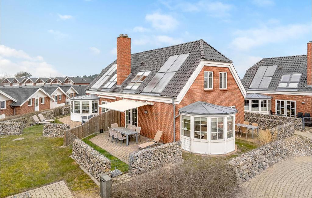 an aerial view of a house with solar panels on it at Cozy Home In Rm With House Sea View in Rømø Kirkeby