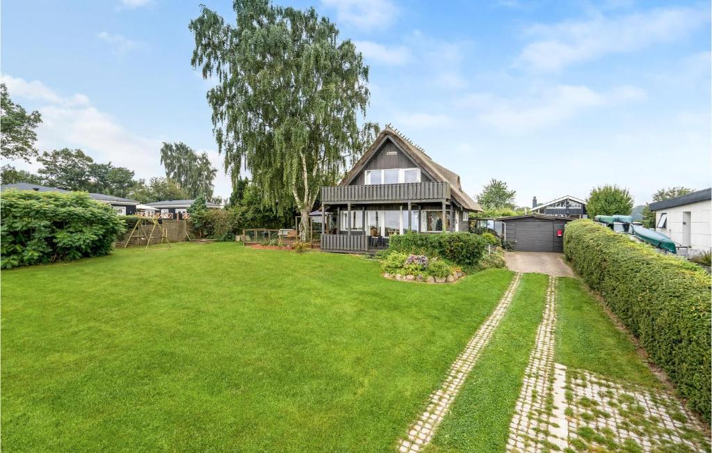 a large yard in front of a house at Lovely Home In Børkop With Wifi in Børkop