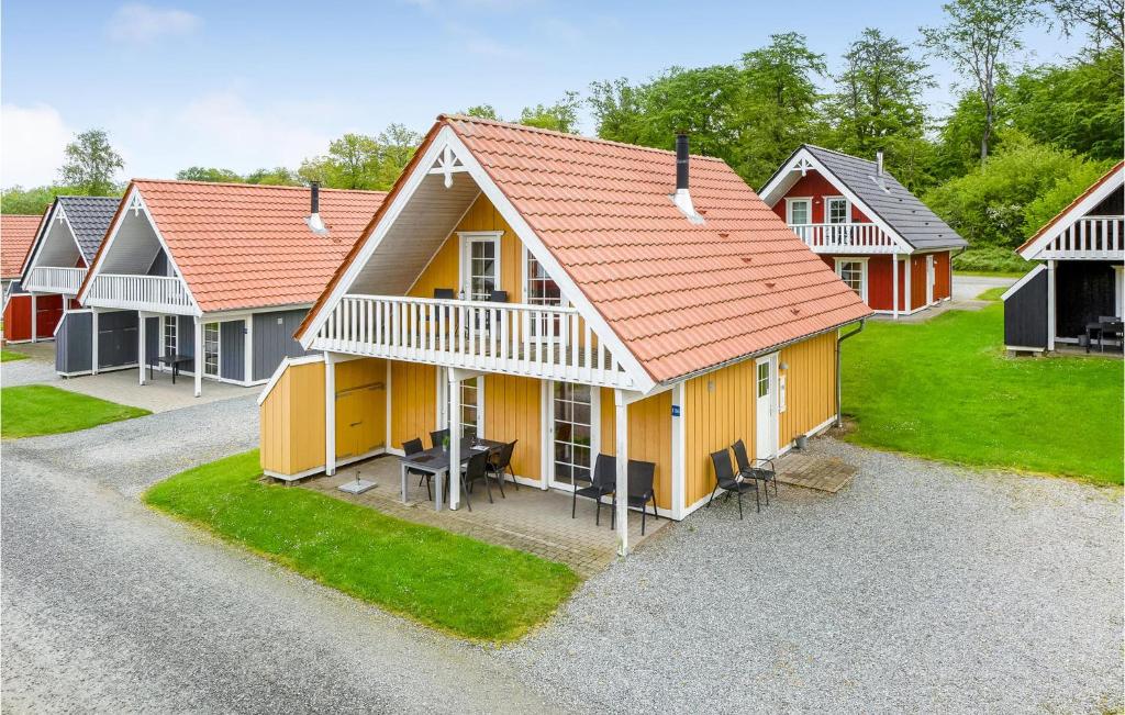 a row of houses with yellow and red roofs at Marina Fiskenæs Feriepark in Gråsten