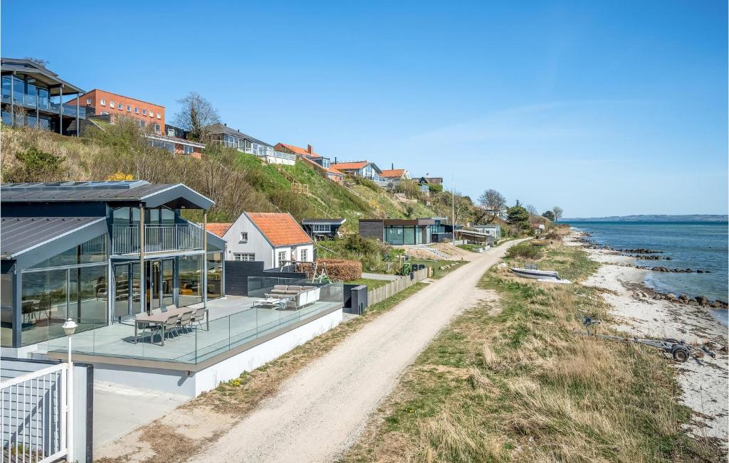 a house on the beach next to the water at Awesome Home In Eg With Kitchen in Egå