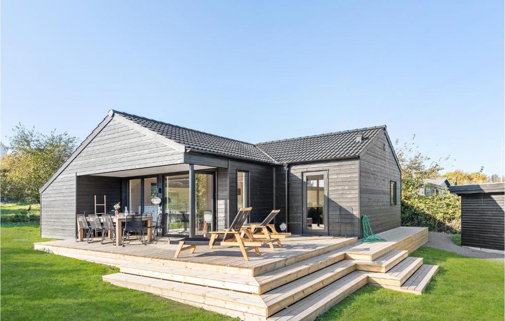 a modular home with a deck and a table at Lovely Home In Allinge With Wifi in Allinge