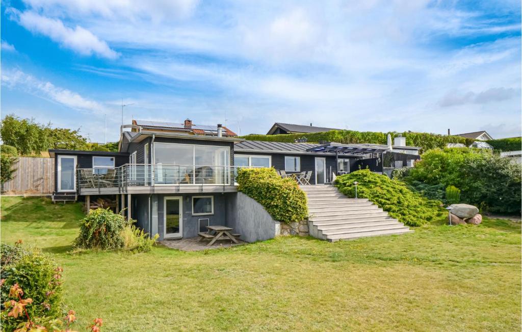 ein großes Haus mit einer Terrasse und einem Hof in der Unterkunft Nice Home In Ebeltoft With House Sea View in Ebeltoft