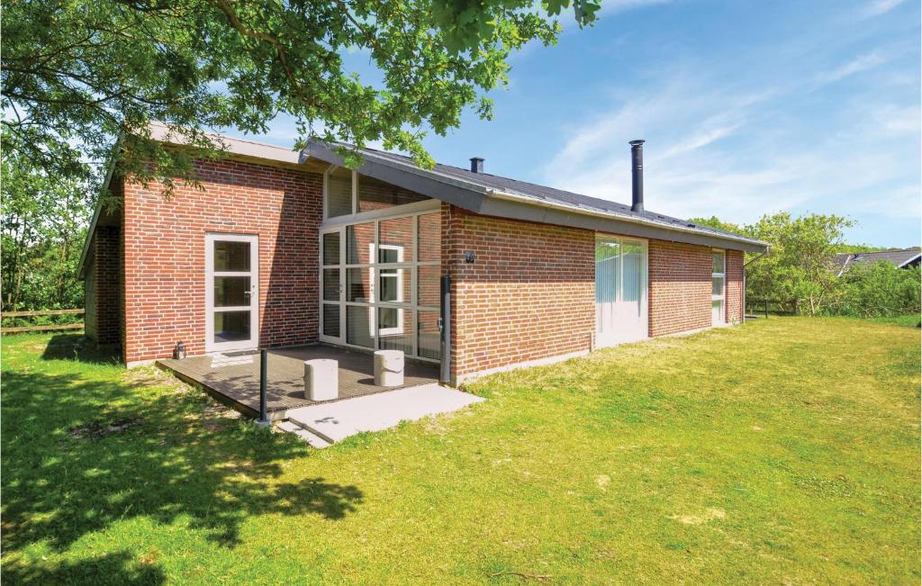 a brick house with a large yard in front of it at 3 Bedroom Awesome Home In Fan in Fanø
