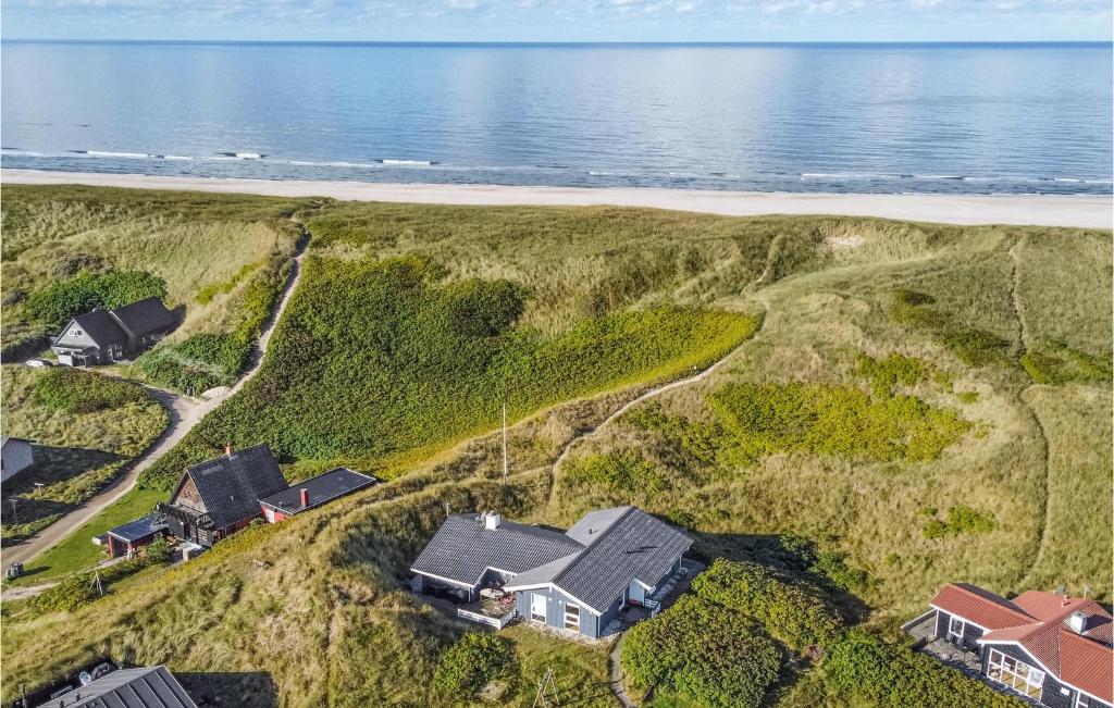 an aerial view of a house on a hill next to the beach at Cozy Home In Hvide Sande With House Sea View in Hvide Sande