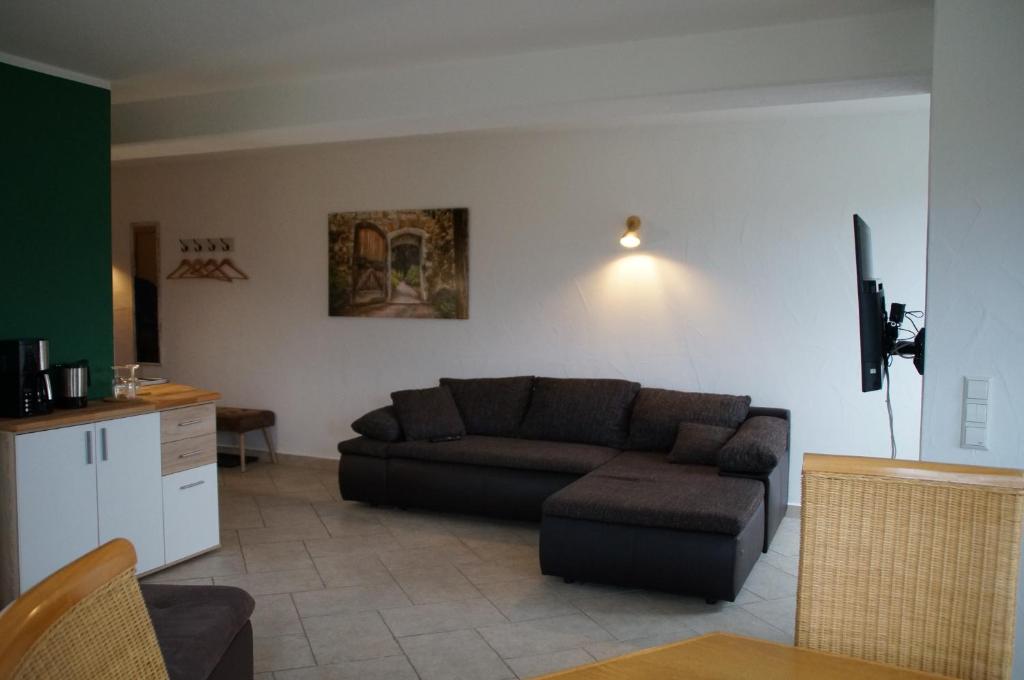 ein Wohnzimmer mit einem Sofa und einem Tisch in der Unterkunft Ferienwohnung Castellberg in Heitersheim