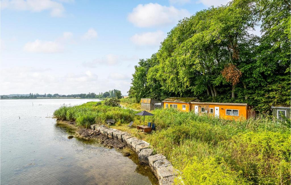a house on the shore of a river at 1 Bedroom Beautiful Home In Bandholm in Bandholm