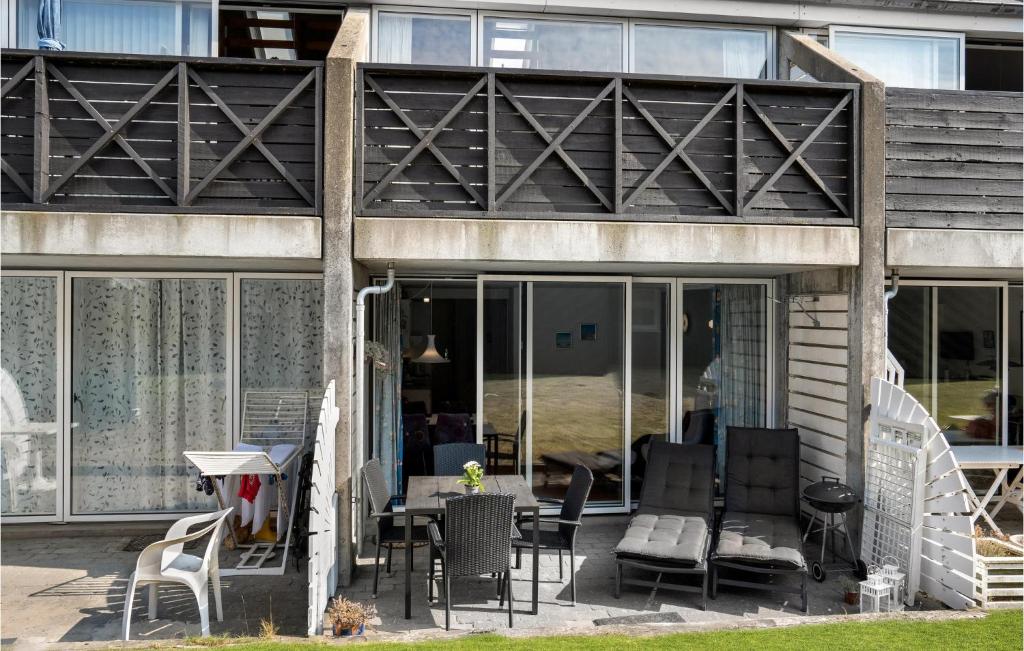 a house with glass doors and a patio at Lejl, 219 St, in Fanø