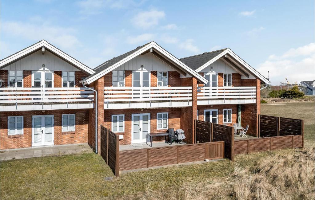 a house with a large deck on a beach at 3 Bedroom Amazing Home In Rm in Havneby