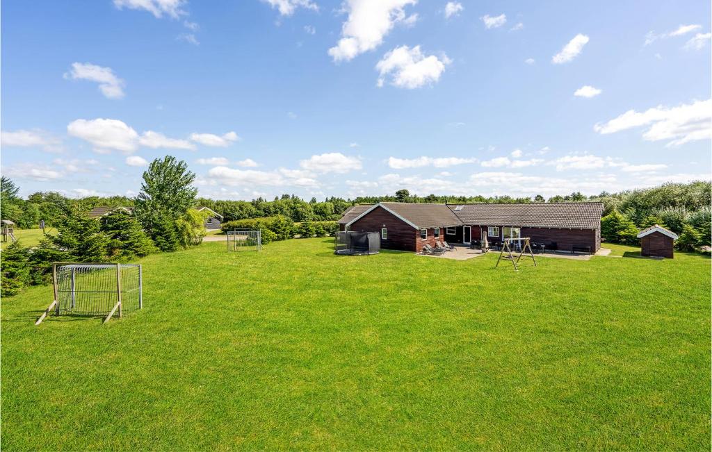a large yard with a house and a soccer field at Stunning Home In Idestrup With Indoor Swimming Pool in Marielyst