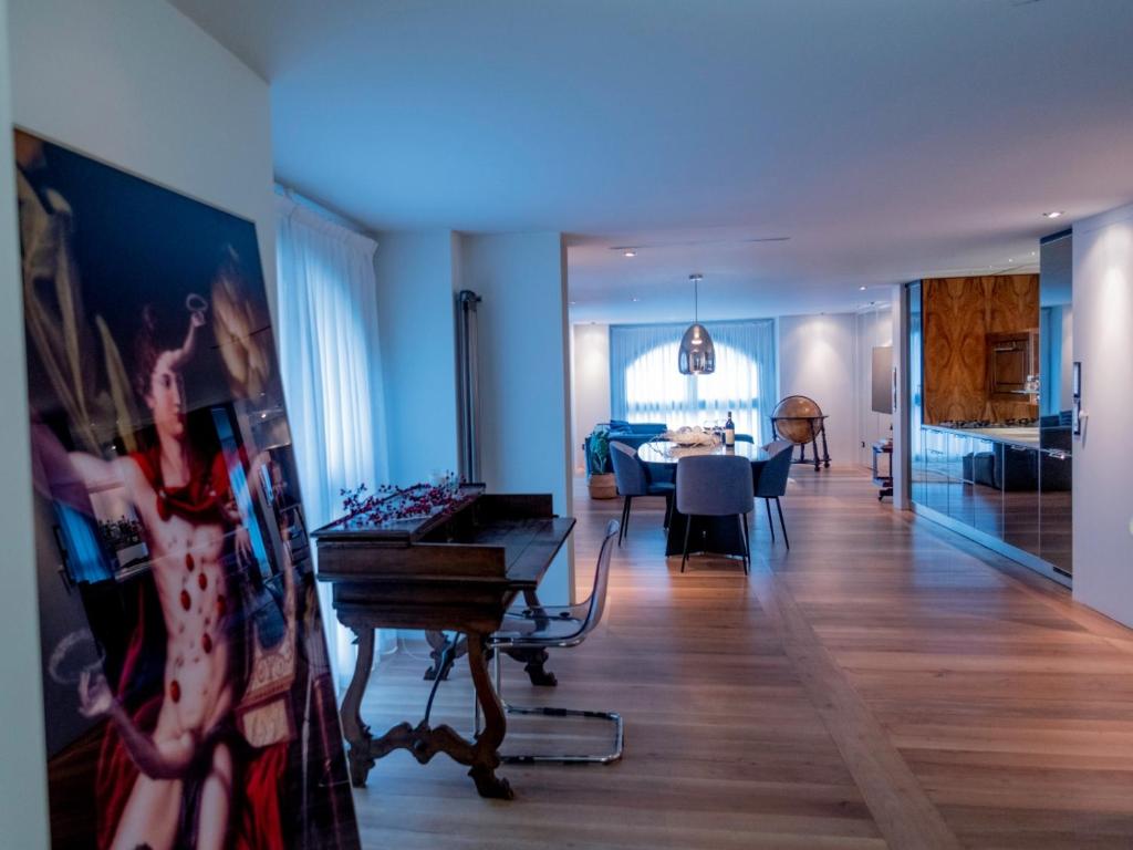 a living room with a piano and a dining room at Luxury apartment (Porta Venezia) in Milan