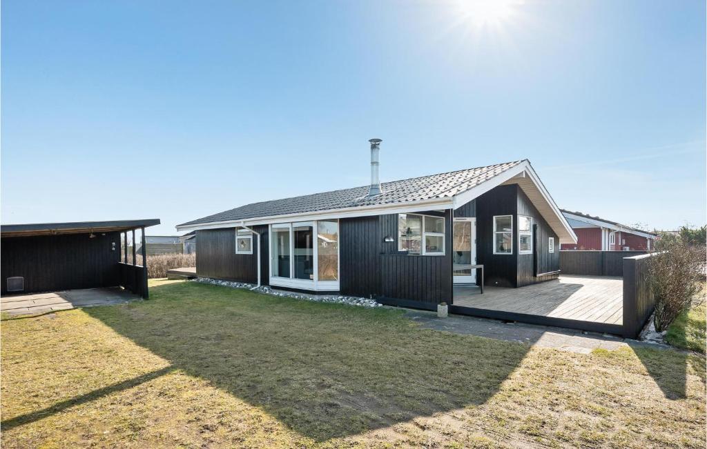 a house with a large yard in front of it at Holiday Home As Strandby Juelsminde X in Sønderby