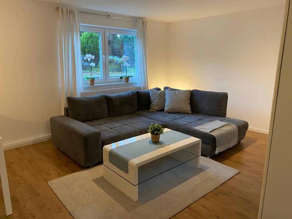 a living room with a couch and a table at Ferienwohnung Welk in Grömitz