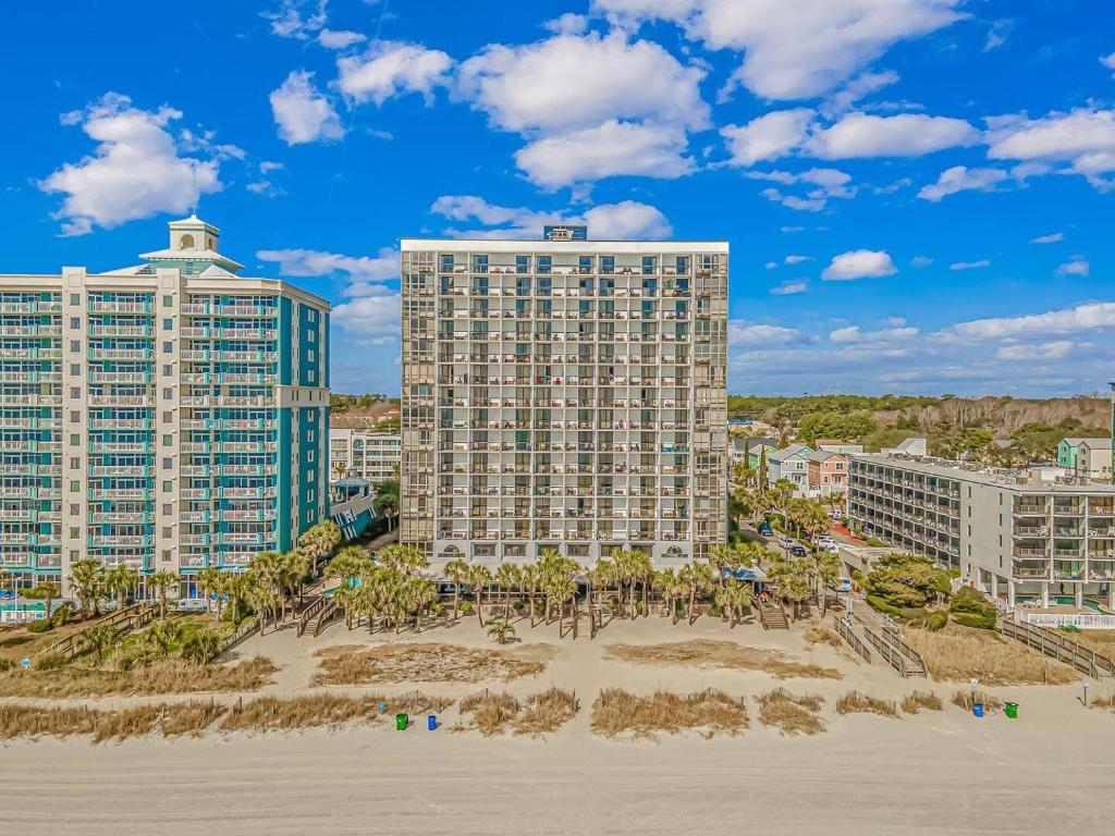 a view of two buildings from the beach at Sun N Sand Resort in Myrtle Beach