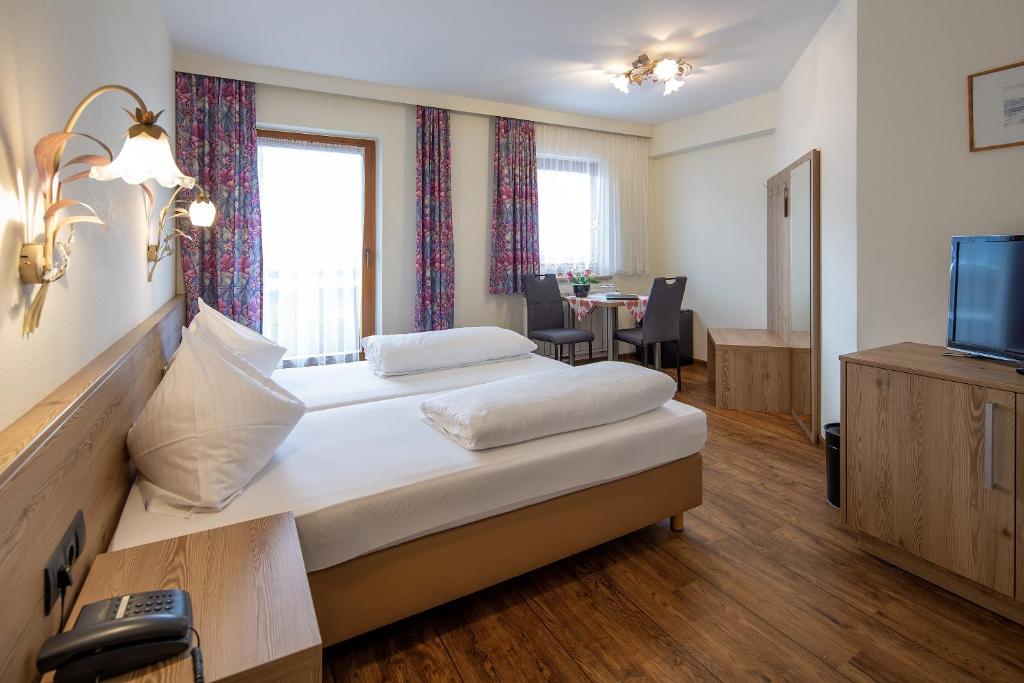 Postel nebo postele na pokoji v ubytování Ferienhotel Fuchs