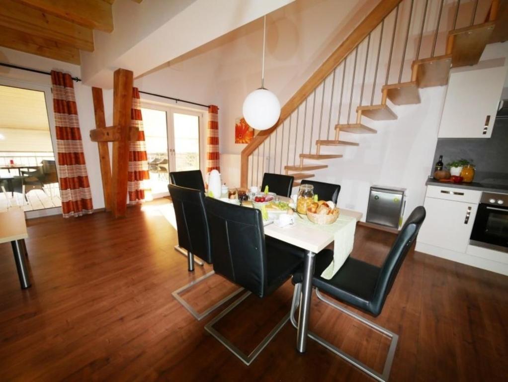 una cucina e una sala da pranzo con tavolo e sedie di Ferienwohnung 3 a Ochsenhausen