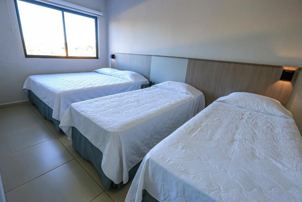 Postel nebo postele na pokoji v ubytování Iguassu Express Hotel