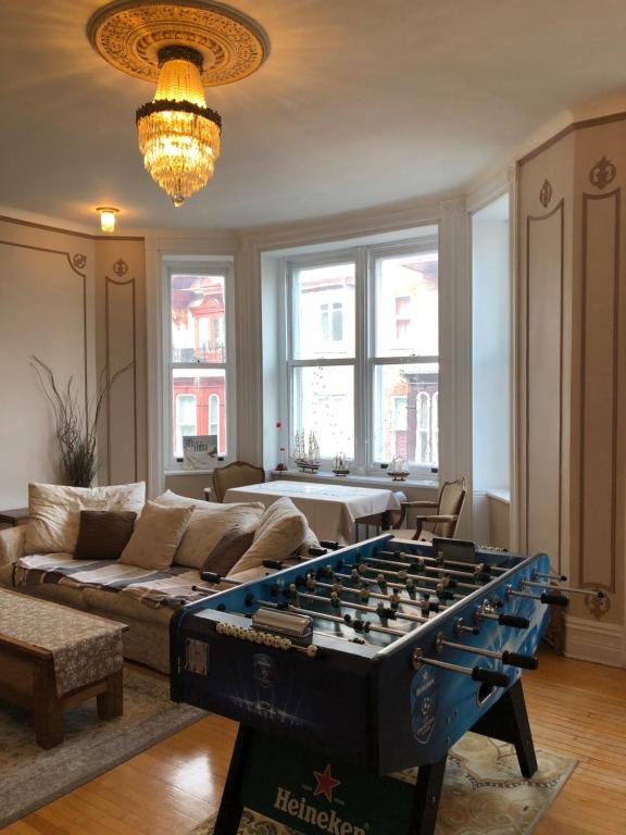 a living room with a foosball table in front of a couch at B&B Chez Hubert in Quebec City