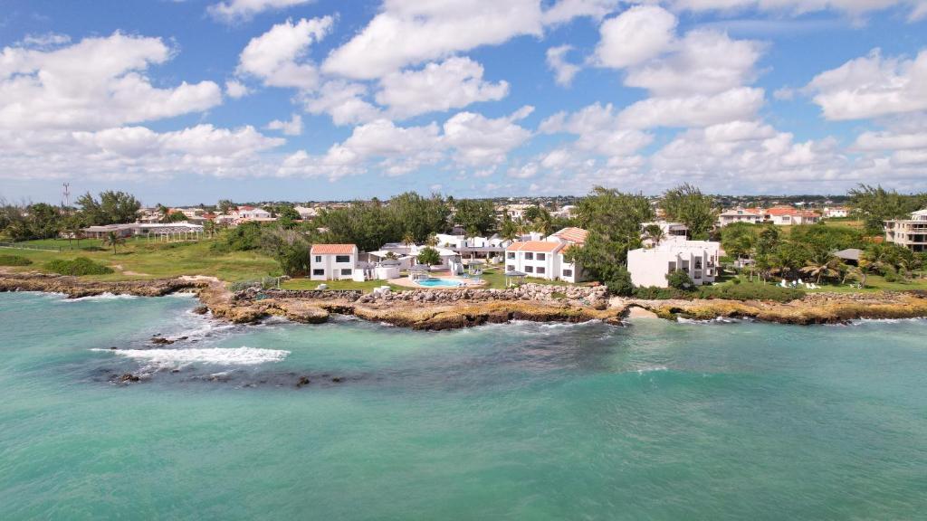 an aerial view of a beach with houses and the ocean at OceanBlue Resort in Christ Church