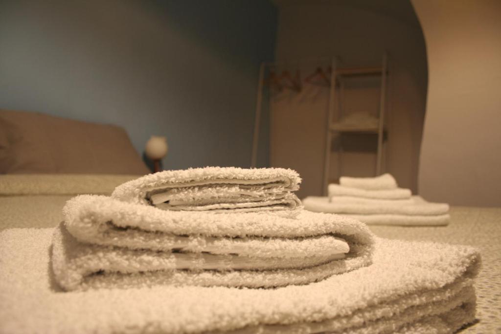 a pile of towels sitting on top of a bed at Valina Apartments in Catania