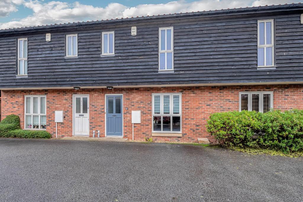 a red brick building with a black roof at 10 St Edmundsbury Mews in Bury Saint Edmunds