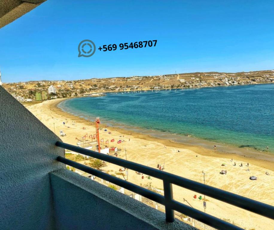 a view of a beach from a balcony at DEPARTAMENTO EN PLAYA LA HERRADURA (CONDOMINIO BAHÍA HORIZONTE) +569 95468707 in Coquimbo