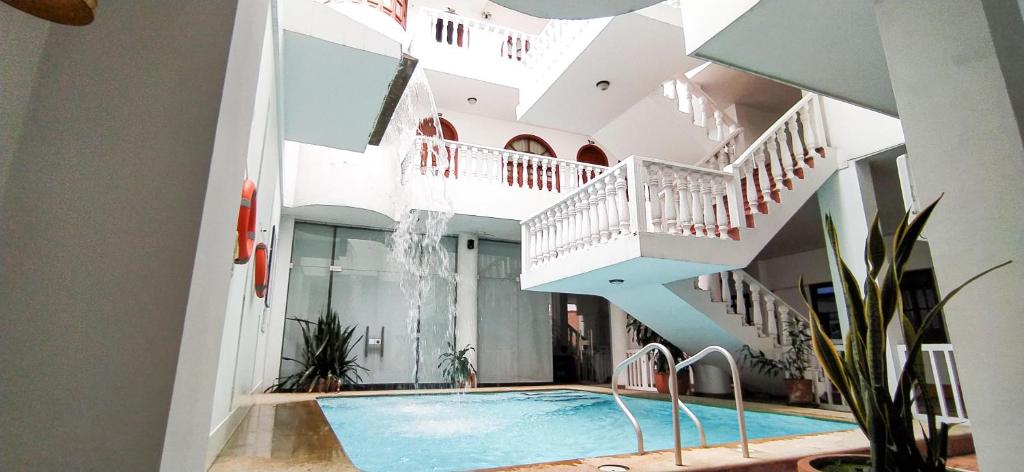 a house with a swimming pool and stairs at Hotel Zaraya in Cúcuta